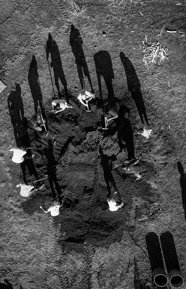a group of people digging in the dirt